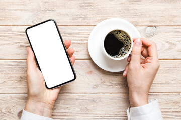 Top view of woman hands holding smart phone with blank copy space screen for your text message or information content. woman hand using phone white screen on top view