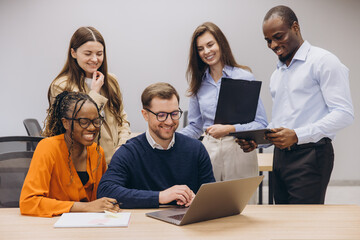 Professional team collaborating, utilizing digital tools for seamless workflow in modern, open plan office environment