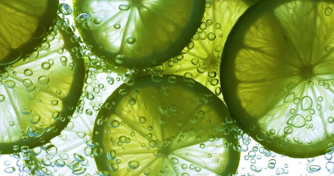Lime Slices falling deeply under water. Shot on super slow motion camera 1000 fps.