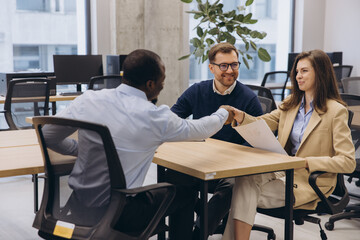 Professionals engaging in a productive meeting, showcasing teamwork and collaboration in a contemporary office environment