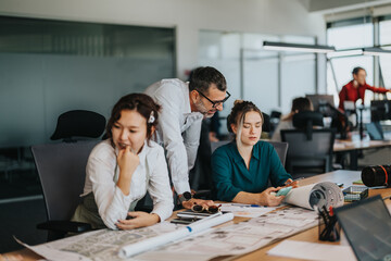 A diverse group of employees actively collaborating and brainstorming strategies in a contemporary office environment, emphasizing teamwork, productivity, and business planning.