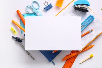 Composition with blank paper sheet and different school stationery on white background © Pixel-Shot