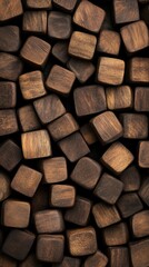 A close-up view of numerous dark wooden cubes arranged haphazardly, showcasing their rich texture and natural grain.