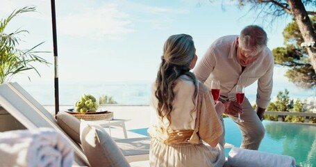 Senior couple, drinks and relax at resort on holiday, vacation and love on valentines day date. Cocktail, man and woman together by swimming pool outdoor for peace, happy or travel in retirement