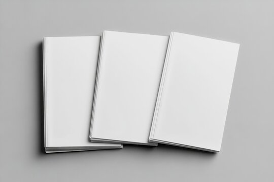 Three blank books stacked on gray background, mockup design