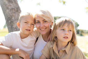 Fototapeta premium Happy mother and children enjoying outdoor time
