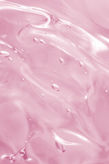 Abstract soft pink liquid with flowing texture and bubbles on a soft pastel background. Elegant and...