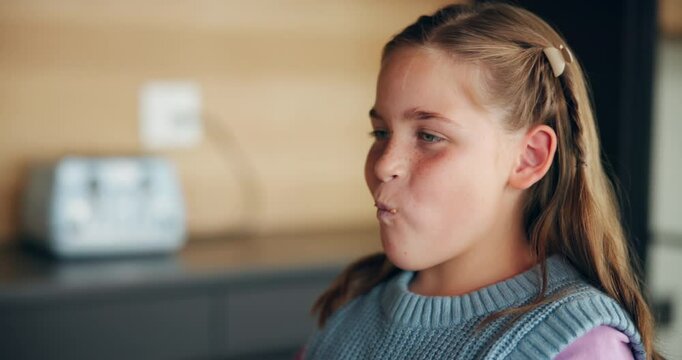 Breakfast, girl and eating a sandwich in home for healthy nutrition, fiber meal and morning routine. Hungry, happy child and peanut butter bread in kitchen for protein diet, lunch and delicious snack
