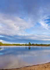 Calm lake with a cloudy sky in the background