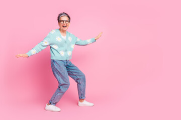 Happy older woman showcasing stylish outfits and enjoying vibrant lifestyle on pink background