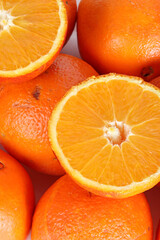 Close-up of whole and sliced oranges, showcasing their vibrant color and juicy texture
