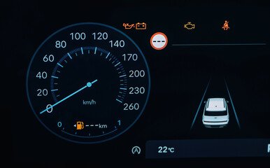 Vehicle is parked. Detailed close up view of speedometer, front panel