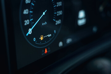 Vehicle is parked. Detailed close up view of speedometer, front panel