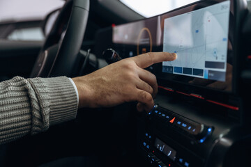 Screen with map, navigation. Man is sitting in car, detailed view
