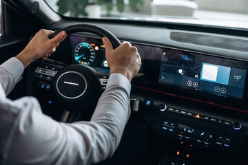 View from behind. Man is sitting in car, detailed view