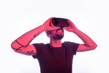 A joyful individual wearing a virtual reality headset against a pink-toned background, capturing a...