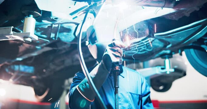 Process, welding and fixing of car, engineer and maintenance of automobile in shop, equipment or skill. Garage, mechanical and person with tools to melt, customization or repairing of damage in store