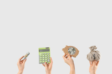Female hands with money, calculator and piggy bank on light background