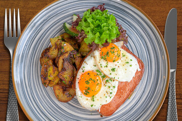 food, baked meatloaf with fried eggs and roast potatoes