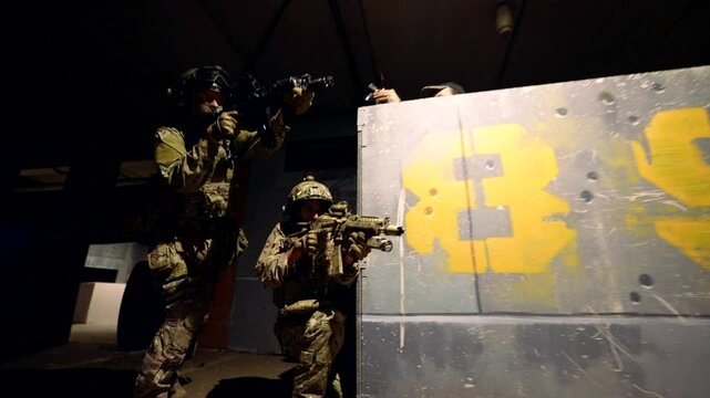 Two commandos on the move in the underground garage, weapons at the ready. Light glare creates dynamics.