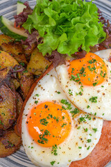 food, baked meatloaf with fried eggs and roast potatoes