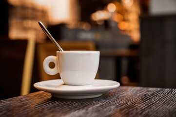 Enjoying a quiet moment with a warm beverage on a cozy table in a bustling cafe during the afternoon hours