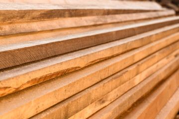 Stacked wooden planks at sawmill, closeup