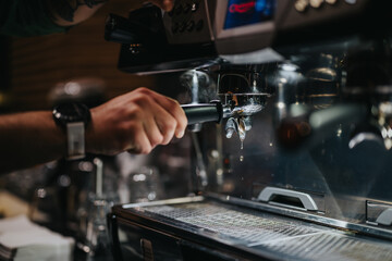 A barista operates an espresso machine, brewing a fresh coffee shot in a modern cafe. The scene depicts the craftsmanship and attention to detail in coffee preparation.