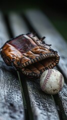 Baseball glove and ball on wooden bench