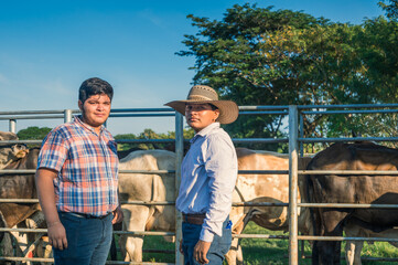 Low angle view of a cattle farm. A campfire can be seen in the foreground.