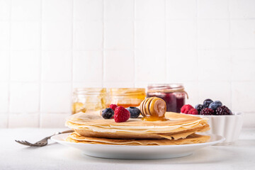 Traditional Maslenitsa food, Eastern European Slavic thin pancakes crepes, with various sweet...