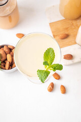 Sweet and sour lemon orgeat cocktail, Orgeat Lemonade Recipe, one martini glass with alcohol boozy drink and almond orgeat syrup bottle