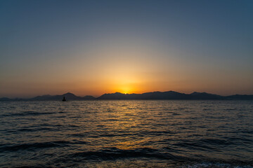View of the sunset over the sea and island