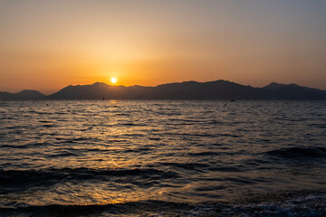 View of the sunset over the sea and island