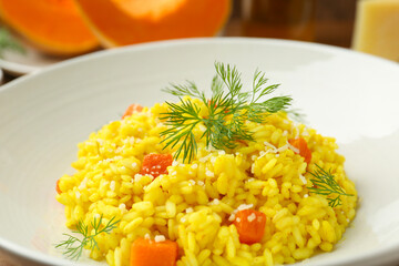 Delicious pumpkin risotto with dill in bowl, closeup