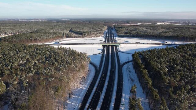 Aerial view of a road junction in a winter landscape. Motorway road junction.