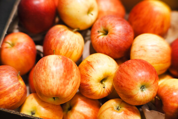 Fresh apples neatly packed in black cardboard boxes, ready for transportation or sale. Warm lighting highlights the natural colors of the fruit. A perfect image for agriculture, food supply, and marke