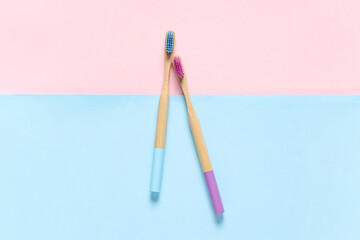 Male and female toothbrushes on color background