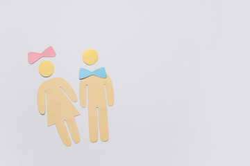 Male and female paper figures with bows isolated on white background