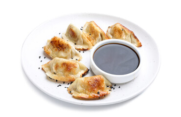Delicious fried gyoza dumplings with sesame seeds and soy sauce isolated on white