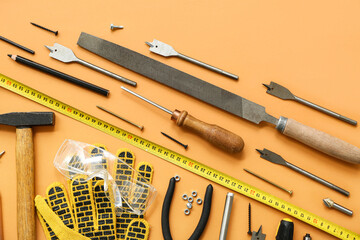 Arrangement of carpenter's tools on beige background