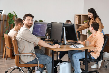 Male programmer working with his team in office
