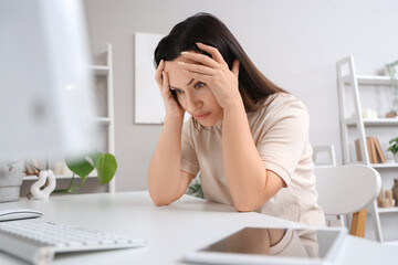 Worried woman sitting at table