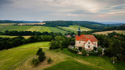 Fototapeta premium St. Wenceslas Church on the outskirts of the village of Chvojinek in the Czech Republic. Photo of the church from above. Aerial photo