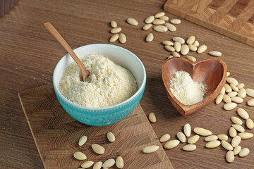 Almond flour in bowl. Nuts on table. Healthy food and products. Organic ingredients and vegan nutrition. 