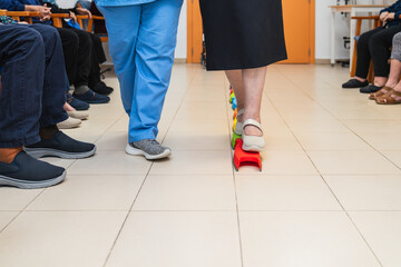 Fototapeta premium Nurse assisting elderly patient with balance exercise