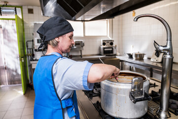 Chef preparing meal in nursing home kitchen