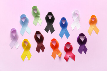 Composition with different satin ribbons on lilac background. World Cancer Day