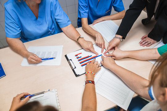 Nurses collaborating on patient care plans in nursing home