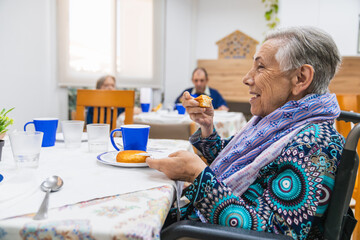 Elderly woman enjoying breakfast in nursing home